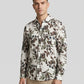 Model looking sideways wearing the botanical leaf print shirt