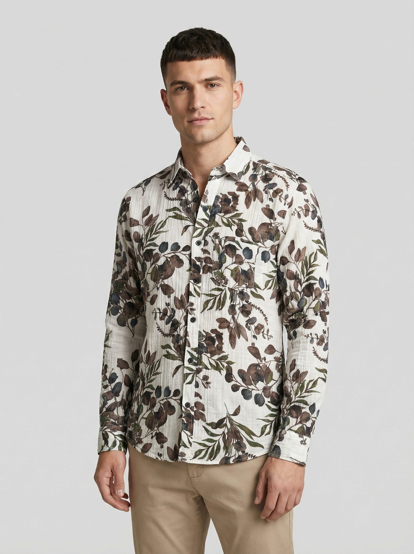 Model looking sideways wearing the botanical leaf print shirt