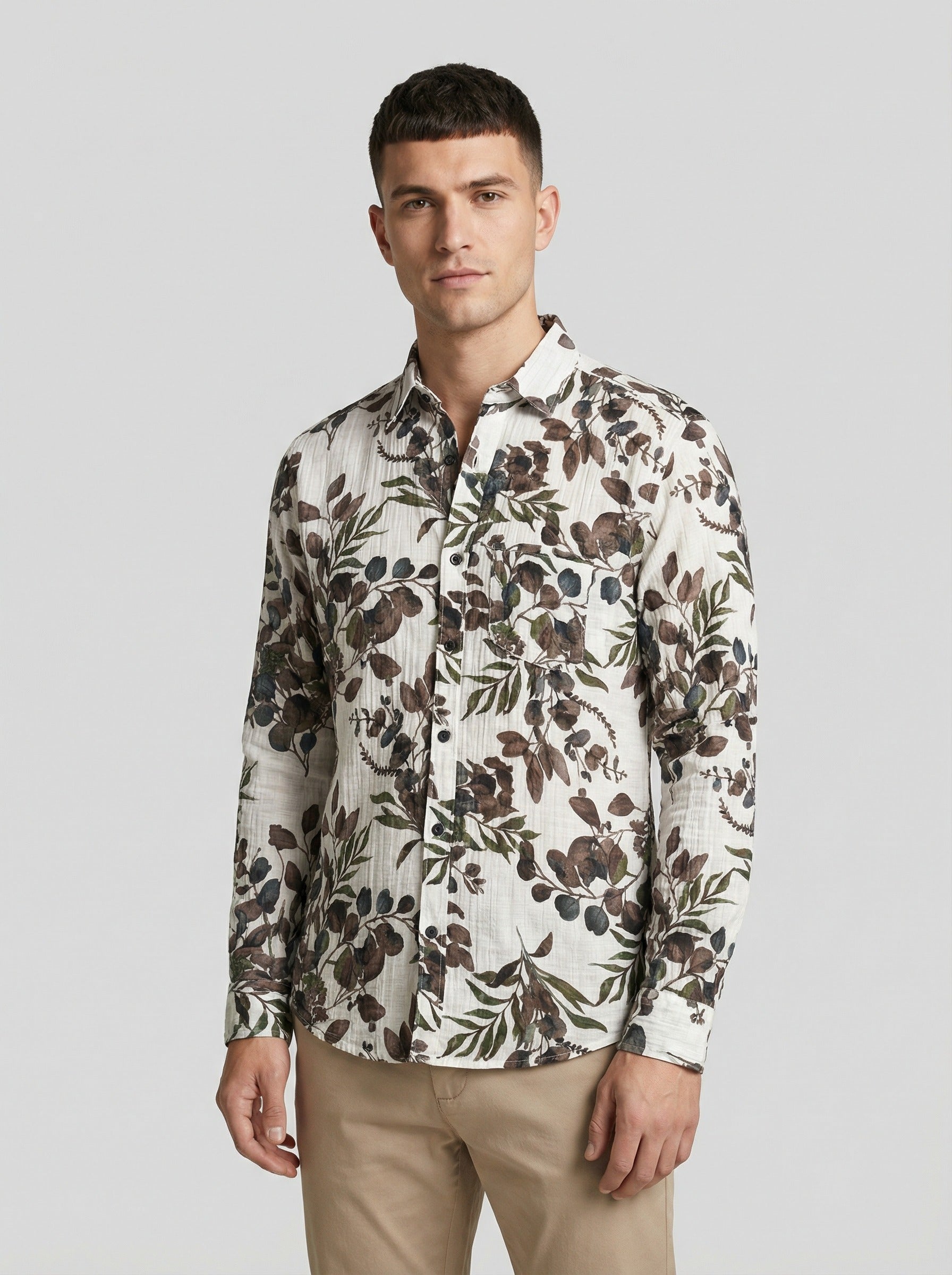 Model looking sideways wearing the botanical leaf print shirt
