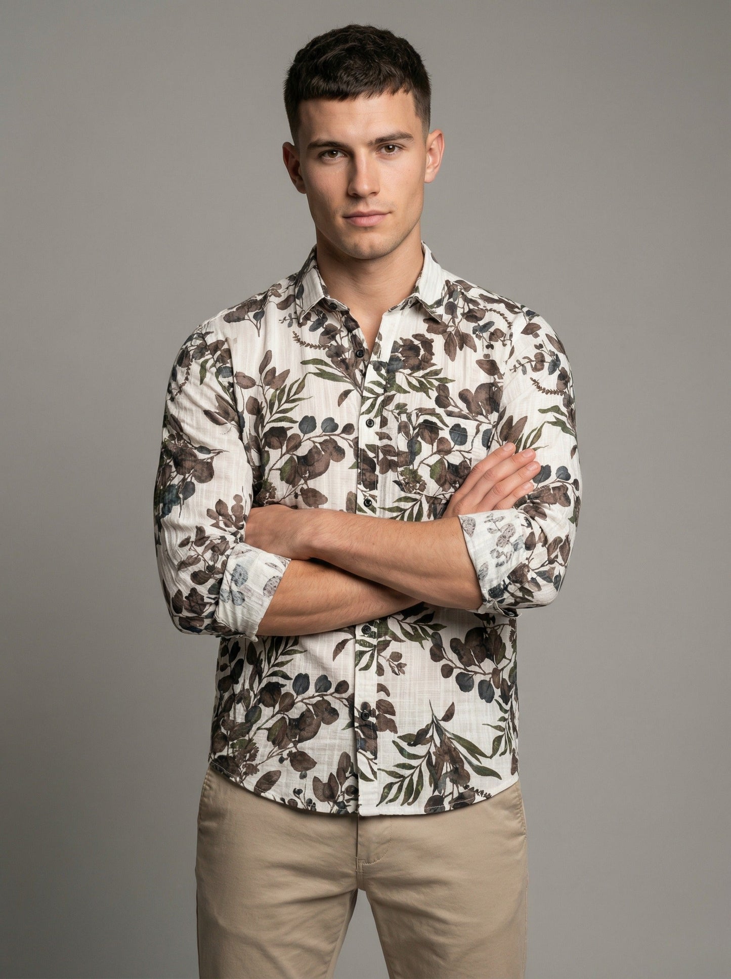 Full length view of model wearing the botanical leaf print shirt and khaki pants