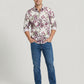 Full body front view of model in Showane purple botanical print shirt and blue jeans