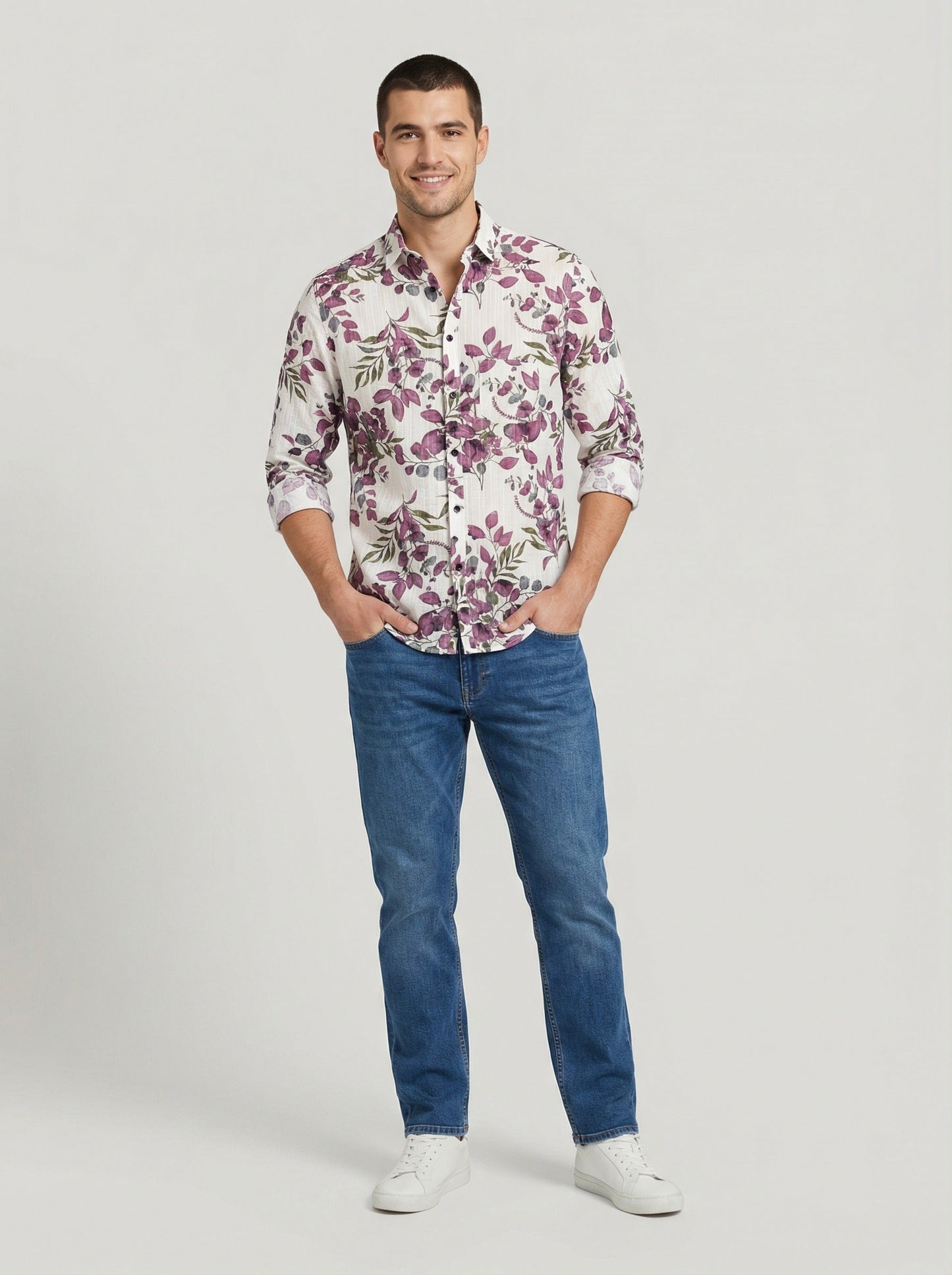 Full body front view of model in Showane purple botanical print shirt and blue jeans