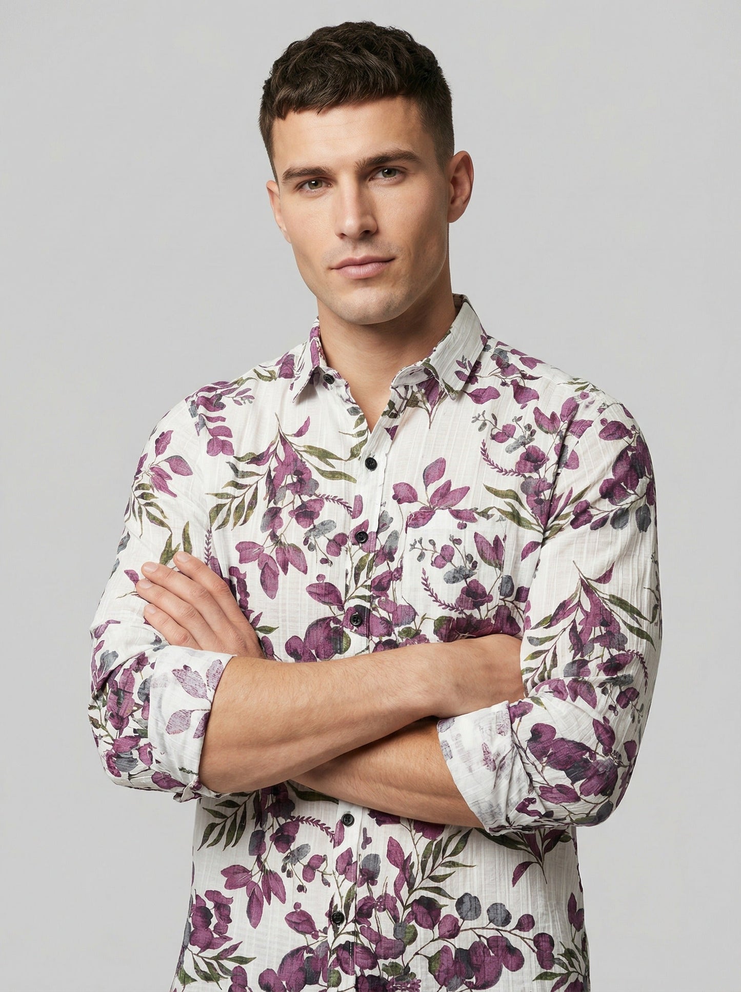 Close-up of model with arms crossed wearing Showane purple floral shirt