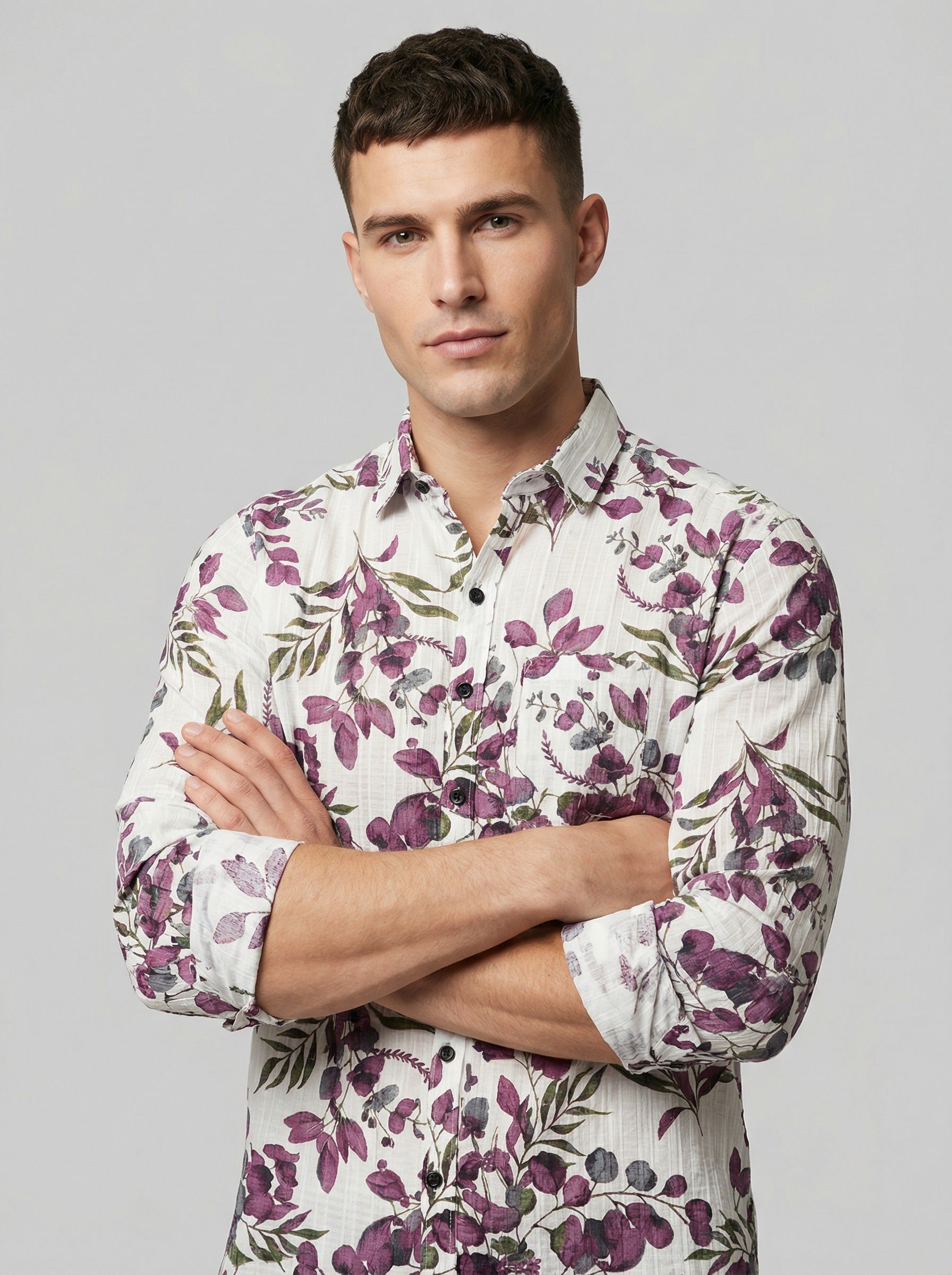 Close-up of model with arms crossed wearing Showane purple floral shirt