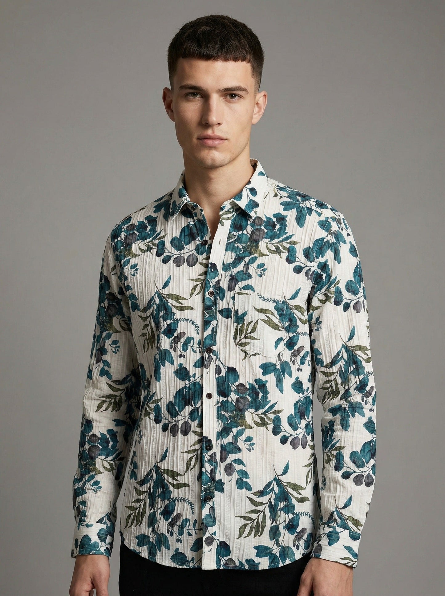 Front view of a man wearing the green leaf print crinkle shirt tucked into dark pants.