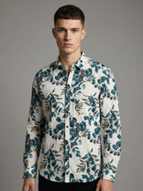 Front view of a man wearing the green leaf print crinkle shirt tucked into dark pants.