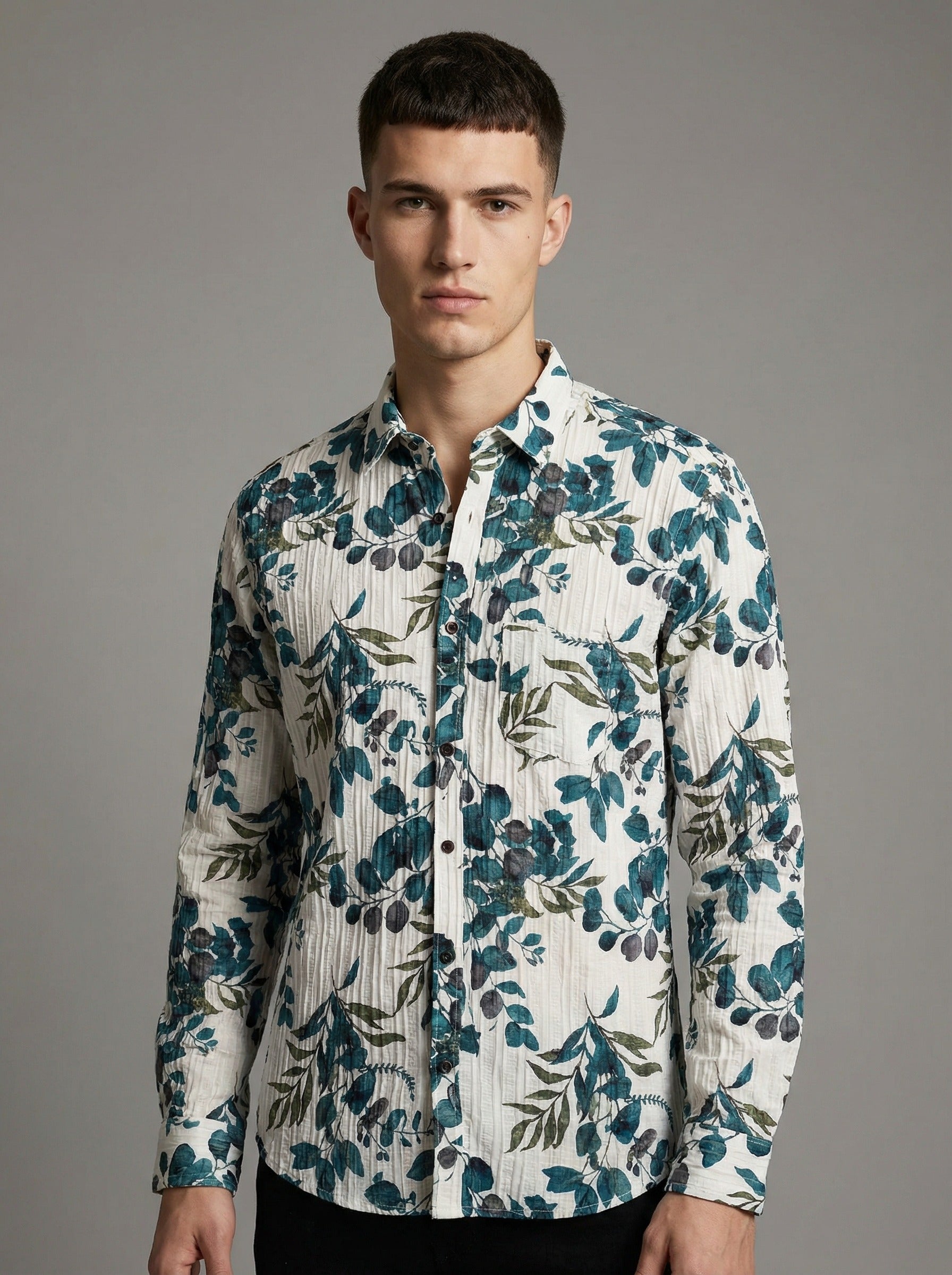 Front view of a man wearing the green leaf print crinkle shirt tucked into dark pants.