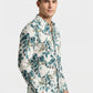 Side profile shot of a man wearing the botanical print shirt with hands in pockets.