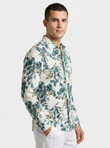 Side profile shot of a man wearing the botanical print shirt with hands in pockets.
